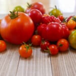 A variety of colorful tomatoes on a wooden table top